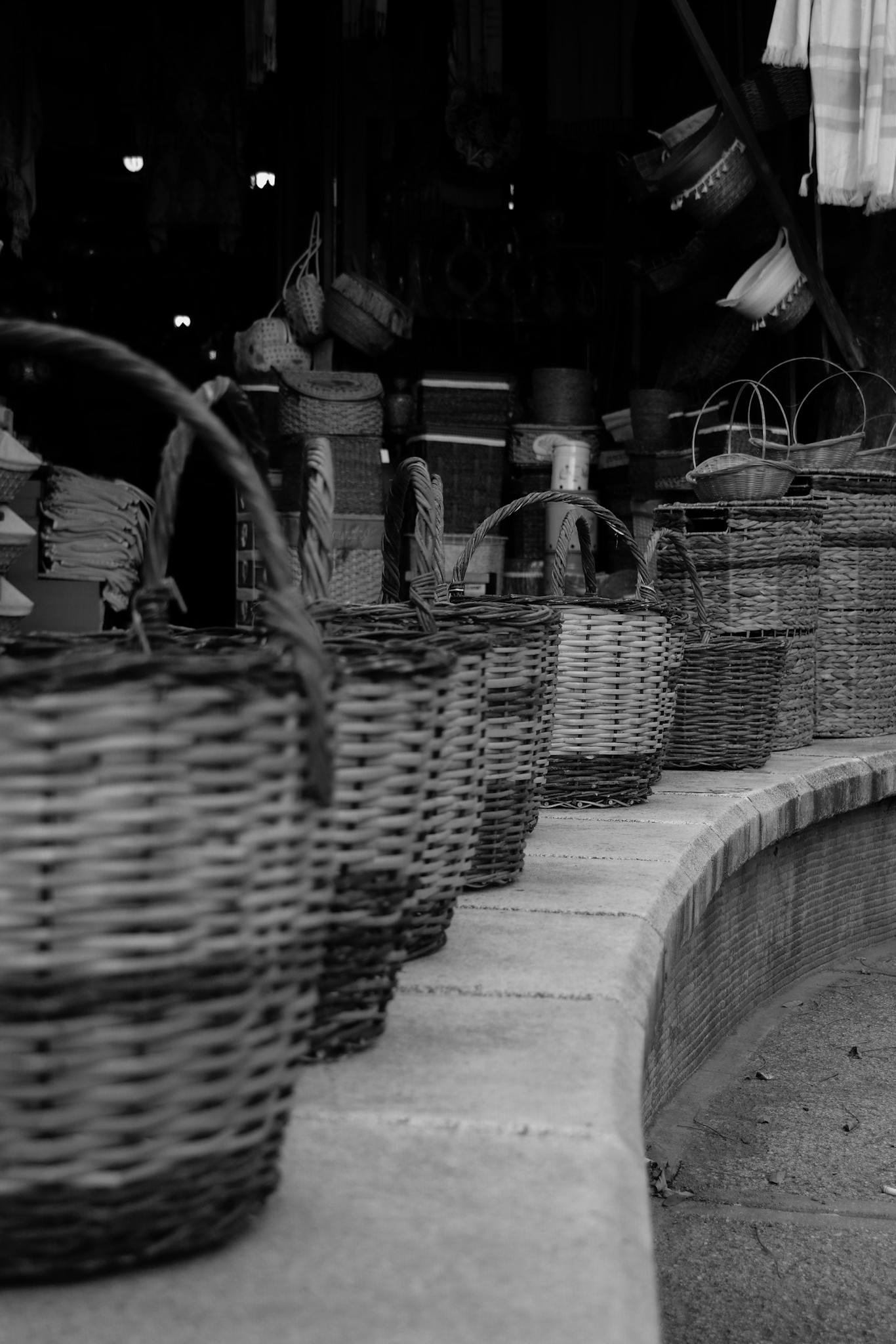 Monochrome image showcasing handcrafted willow baskets in a Turkish bazaar.